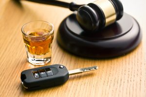 Keys, shot of alcohol and gavel